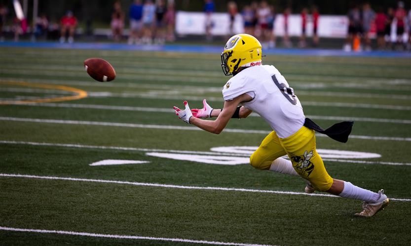 A football player prepares to catch the ball